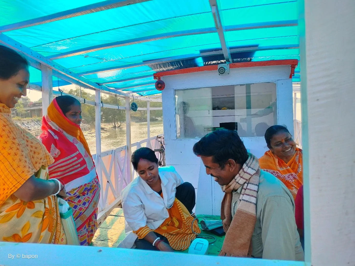 Community health worker screening patients on a floating clinic